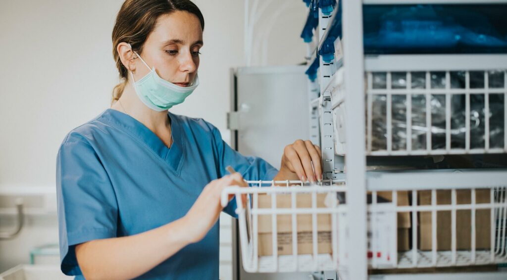 Stainless-steel-wire-baskets-in-hospital-setting nurse pulling medical supplies from a wire basket